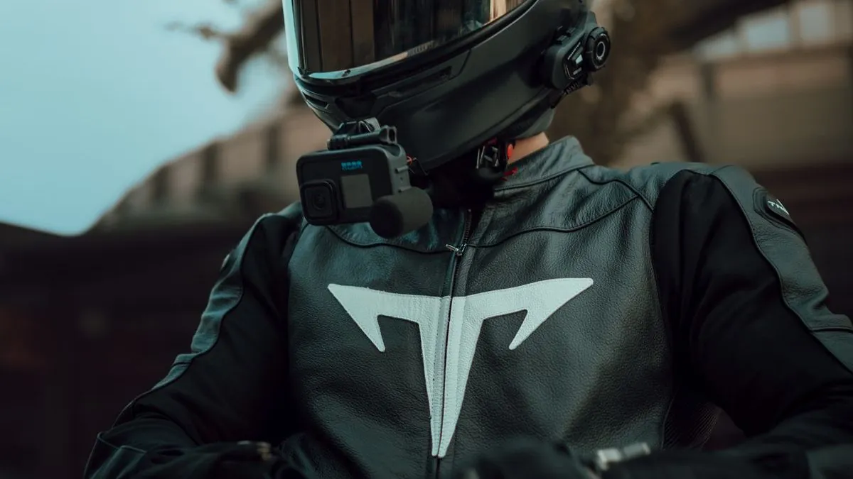 Motorcyclist wearing helmet with action camera
