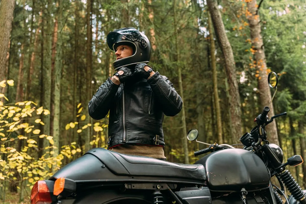 Rider in leather gear preparing for a motorcycle journey