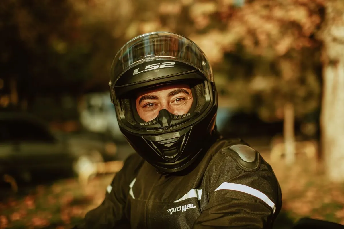 Close-up of motorcyclist wearing protective gear and helmet