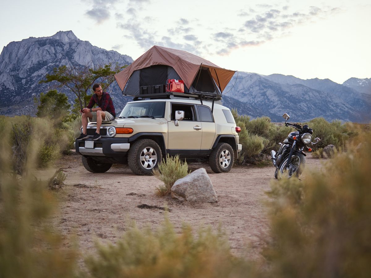 Outdoor camping setup with vehicle and tent