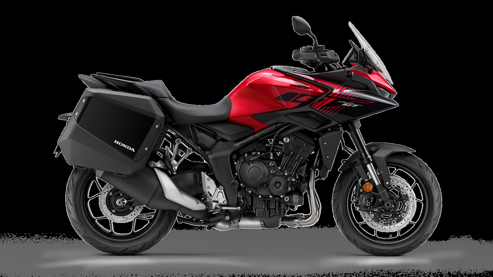 2026 Honda CB1000GT in Grand Prix Red showing the Fireblade-derived inline-4 engine and sport-touring bodywork with panniers