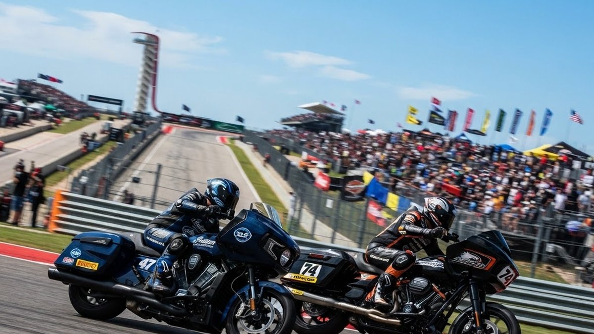 Bagger motorcycles racing uphill into Turn 1 at Circuit of the Americas during a King of the Baggers race