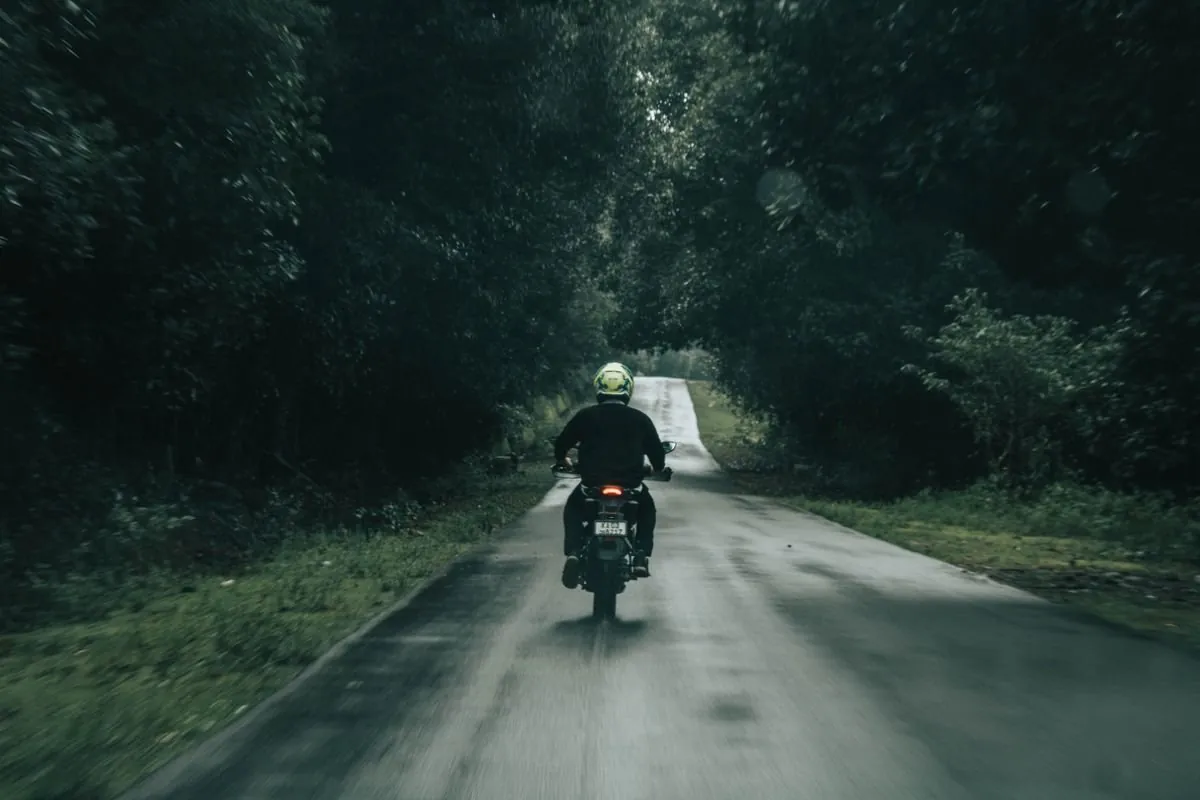Solo motorcycle rider empty highway mountains