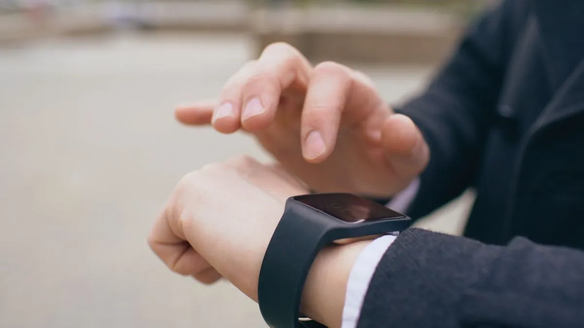 Smartwatch showing heart rate data outdoors