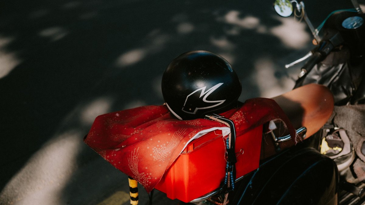 Motorcycle touring gear and accessories laid out showing essential items for long-distance riding