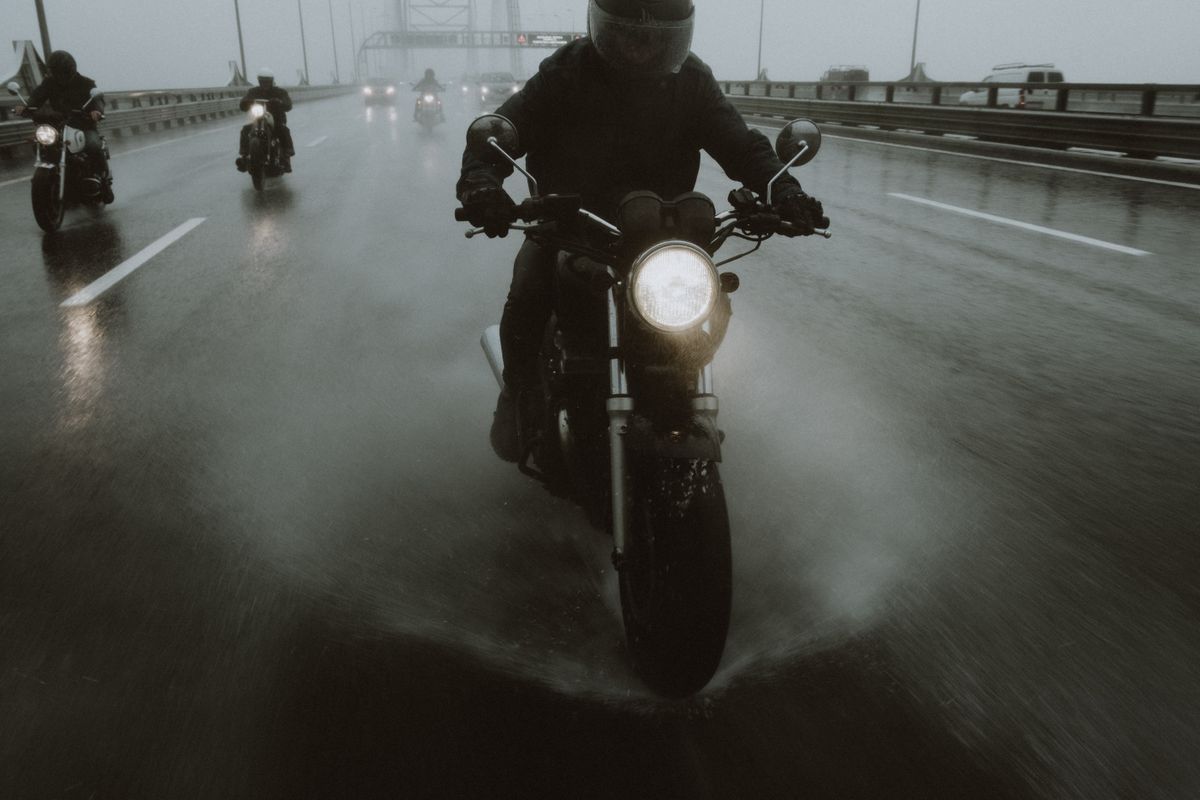 Motorcyclists riding through rain — wet boots are a constant problem for riders on the road