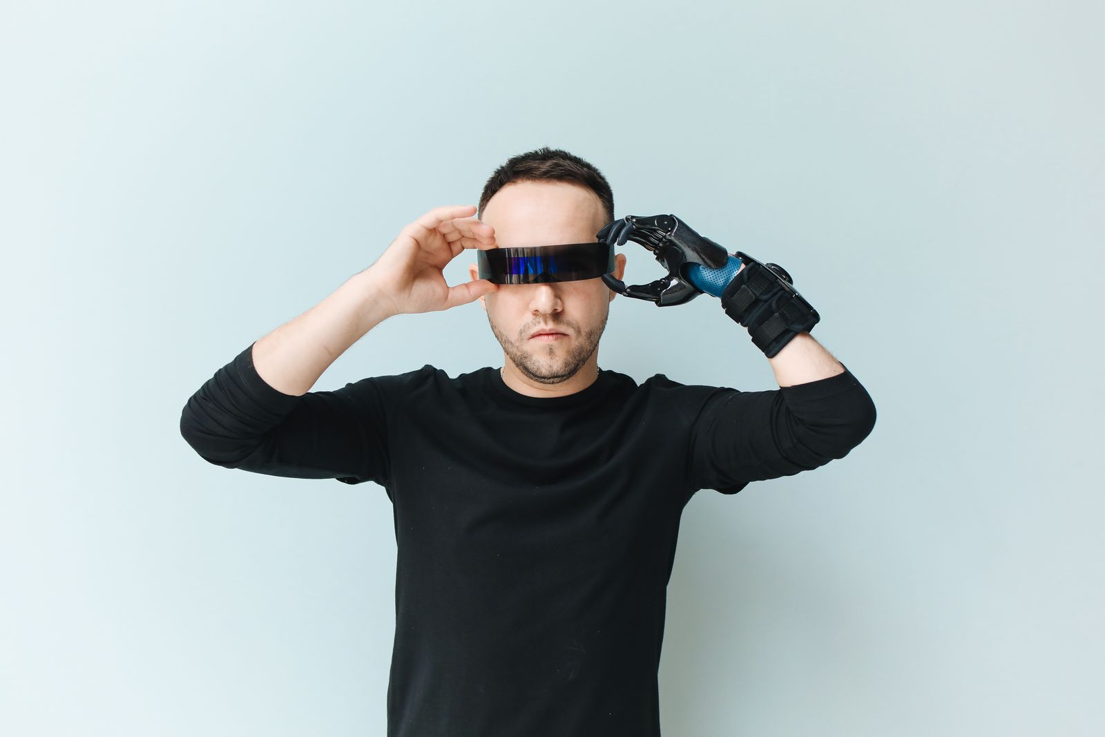 Person adjusting futuristic smart glasses