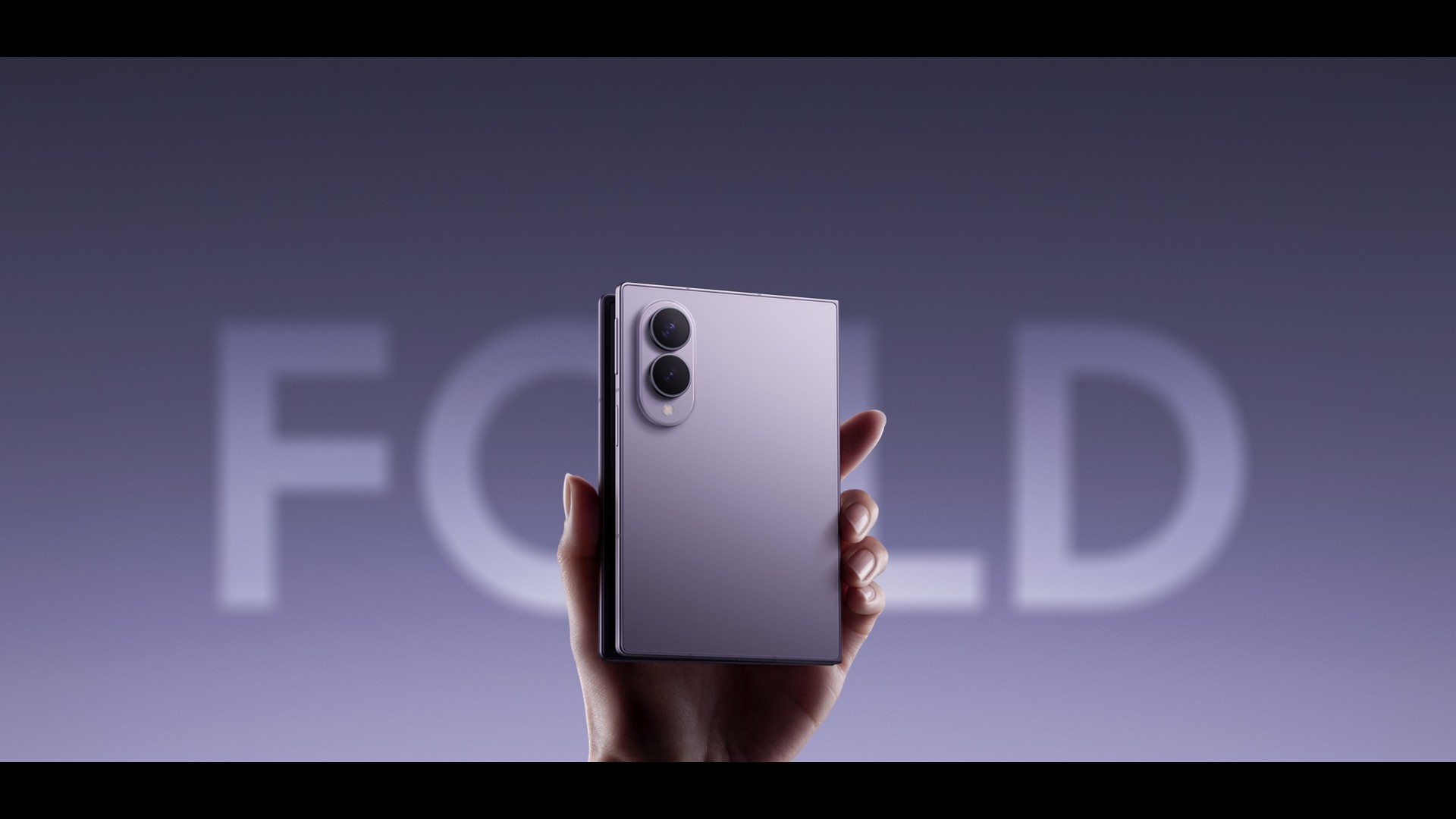 Open foldable smartphone on a dark desk
