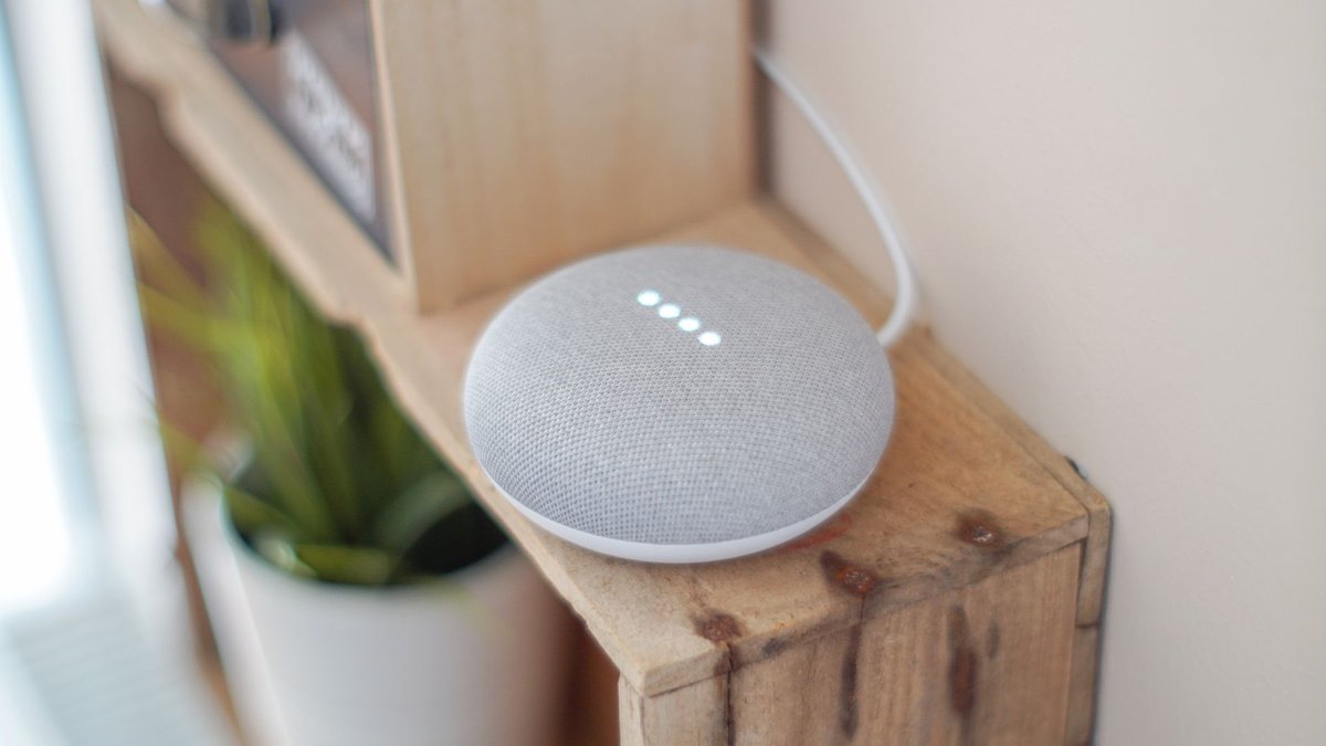 Smart home devices including speakers, cameras, and smart plugs arranged on a counter